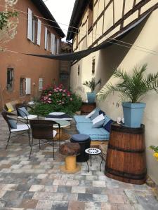 a patio with furniture and a table and chairs at Caveau 1751 in Niedermorschwihr
