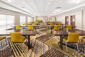 a conference room with tables and yellow chairs at Holiday Inn Express & Suites - Suisun City, an IHG Hotel in Suisun City