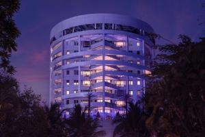 a tall building with lights on at night at Taj Wellington Mews in Mumbai