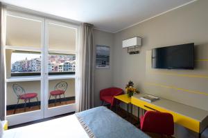 a hotel room with a bed and a desk and a window at Grand Hotel Portovenere in Portovenere