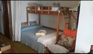 a bedroom with two bunk beds and a chair at Ecológico en plena naturaleza in Riaza