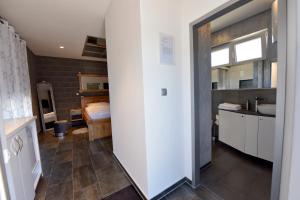 a room with a bathroom with a sink and a counter at Apartmani i Bungalovi TROJKA in Banja Luka