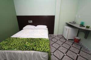 Un pat sau paturi într-o cameră la Hotel Lagoa