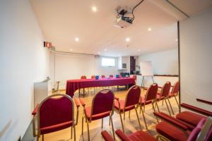 a conference room with a red table and chairs at Hotel Terme Delle Nazioni in Montegrotto Terme +64 photos