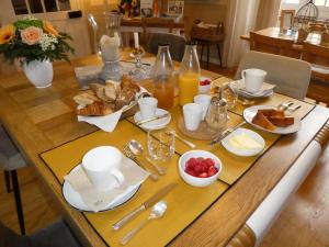 a wooden table with breakfast foods on it at Chalet Mina in Sazos