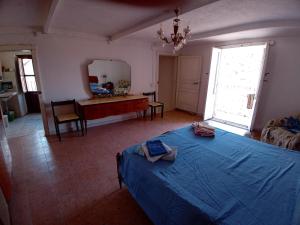 a bedroom with a bed and a table and a mirror at Enjoy Badolato! in Badolato