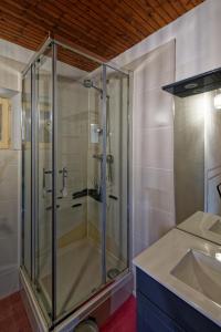 a glass shower in a bathroom with a sink at Gîte de la Forge in Saint-Léger-des-Prés