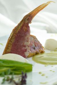 a piece of meat and vegetables on a plate at Grand Hotel Portovenere in Portovenere
