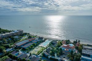an aerial view of a resort next to the water at Coral Tree Villa Huahin in Cha Am