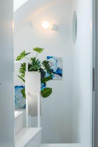 a white stair case with a plant in it at Kyklos Villas - luxury villas with private pool in Karterados