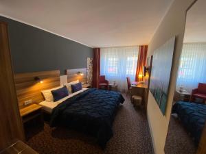 
Ein Bett oder Betten in einem Zimmer der Unterkunft Hotel Am Schloss Ahrensburg
