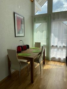 a dining room with a wooden table and chairs at Sunshine in Messen