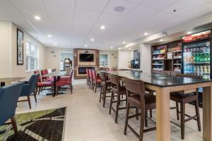 a bar with chairs and tables in a restaurant at Holiday Inn Express - Plymouth, an IHG Hotel in Plymouth