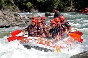 a group of people in a raft in a river at Hotel Or Blanc in Espot