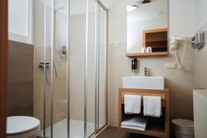 a bathroom with a shower and a toilet and a sink at Pension Pirkdorfer See in Sankt Michael ob Bleiburg