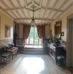 a room with a table and chairs and a large window at Propriété Les Ruisseaux in Seine-Port