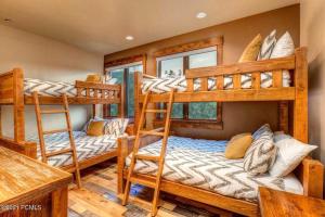 a bedroom with three bunk beds in a house at The Perch Park City - Magnificent 6 BR House With Views, Elevator, Game Room, Hot Tub in Park City