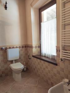 a bathroom with a toilet and a sink and a window at B&B Santa Cristina in Montichiari +35 photos