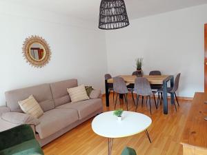 a living room with a couch and a table at Origen Pelaire Refugio Tena Centro Biescas con encanto UbicacionTop in Biescas