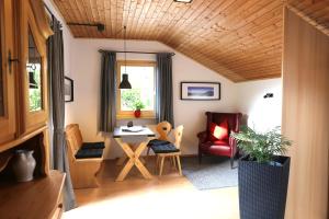 a living room with a table and a chair at Ferienwohnungen Mittermayer in Aschau im Chiemgau