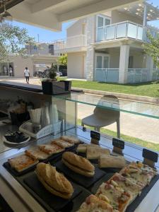 a display case with various types of bread and pastries at Pietra Bianca Marzamemi in Marzamemi