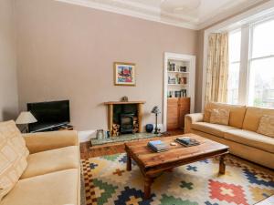 a living room with a couch and a coffee table at Struan House in Aberfeldy