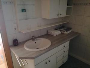 a bathroom counter with a sink and a mirror at Gästehaus Lemmerer in Obersdorf