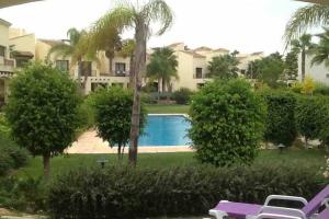 a view of a house with a swimming pool at Roda Golf & Beach Resort. Townhouse, Poolside in Murcia
