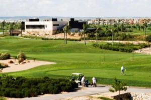 a group of people playing golf on a golf course at Roda Golf & Beach Resort. Townhouse, Poolside in Murcia