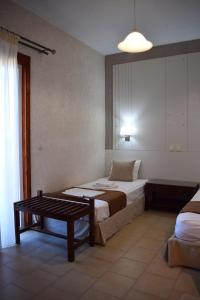 a bedroom with a bed and a table in it at Altis Hotel in Malia