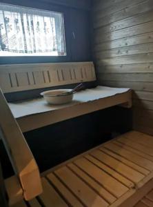 a bowl sitting on a counter in a wooden room at Pajala, talo aavan reunalla in Nivala