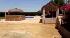a yard with a pool and a building with a building at شاليه بالساحل الشمالى* in Kafret Eilet el Taflal
