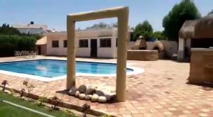 a swimming pool in front of a house at شاليه بالساحل الشمالى* in Kafret Eilet el Taflal