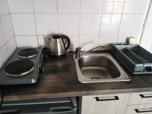 a kitchen counter with a sink and a stove at Spiros Sea View in Nydri