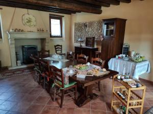 a dining room with a table and chairs and a fireplace at B&B Santa Cristina in Montichiari