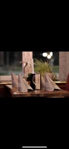 a table with a glass of wine and white envelopes at Hotel Boxberg in Waldbröl