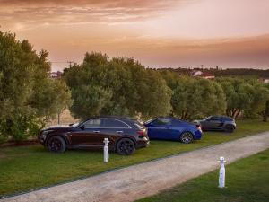 three cars parked on the side of a road at Villa Scorpion Nea Moudania Halkidiki in Nea Moudania