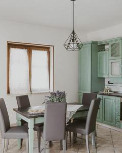 a kitchen with a dining room table and chairs at Villa Santimone in Eboli