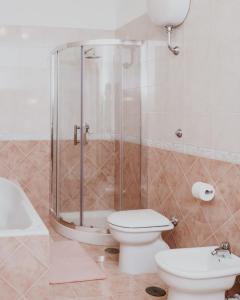 a bathroom with a shower and a toilet and a sink at Villa Santimone in Eboli