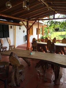 a large wooden table and chairs on a patio at CABAÑA LOS NOGALES in San Agustín