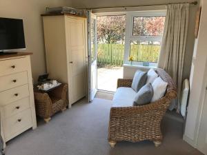 a living room with a couch and a window at Haven House B&B in Beadnell