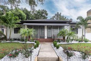 a house with a garden in front of it at Cozy Apartments in the Triplex House, Historic District of Orlando in Orlando