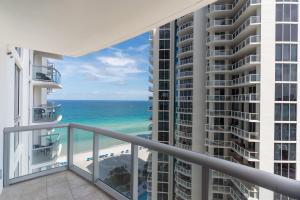 a balcony with a view of the beach and ocean at Sunny Isles 1BDR Sea View and Pool in Miami Beach