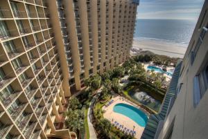 an aerial view of a hotel with the ocean in the background at Palmetto Vacation Rentals at Kingston Plantation in Myrtle Beach
