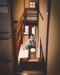 a girl sitting on the floor in a stair case at Machiya Kikunoya in Nagoya