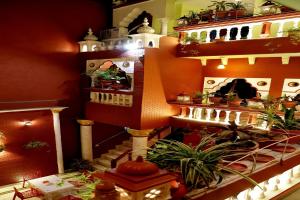 a model of a house with plants on a shelf at Ganesha Palace in Amritsar