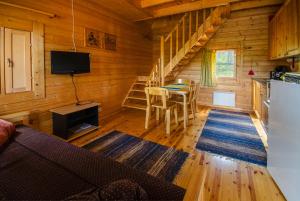 a log cabin with a kitchen and a dining room at Ahvenlampi Camping in Saarijärvi