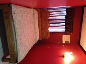 a bedroom with a bunk bed with a window at RM Guest House in Dumaguete