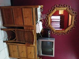 a mirror and a tv in a room at RM Guest House in Dumaguete