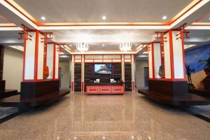 a lobby with red and white columns and a television at Kiang Haad Beach Hua Hin in Hua Hin
